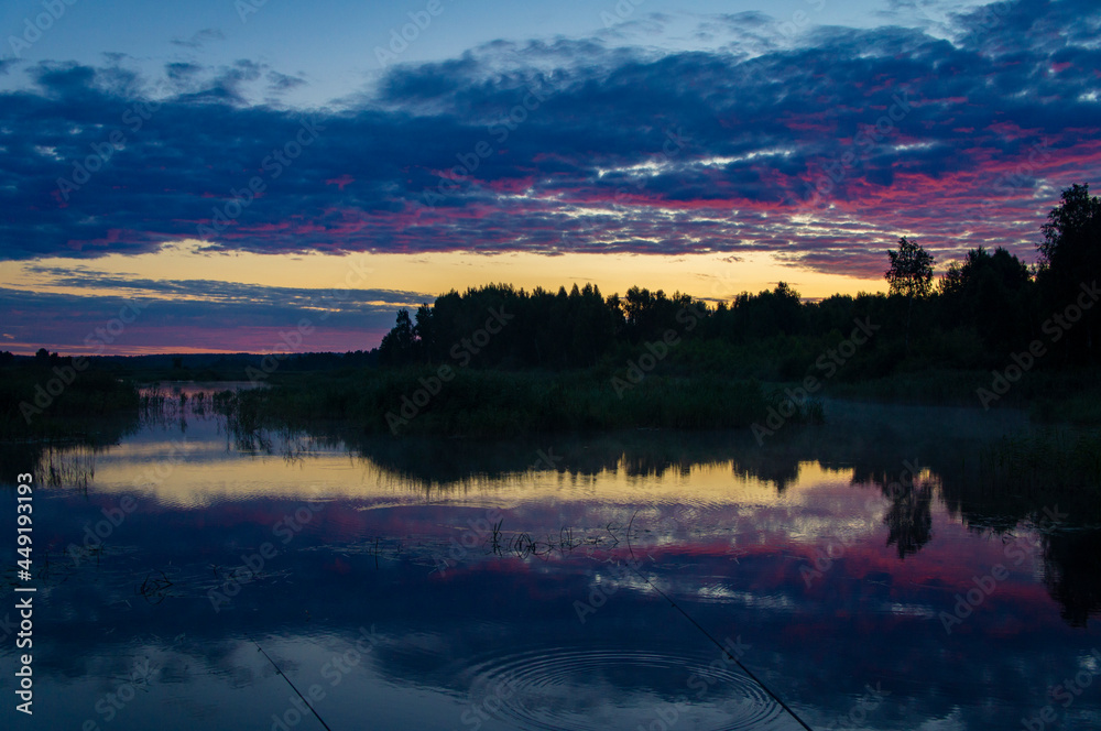 Beautiful calm purple landscape at the sunset of the lake