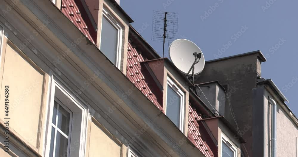 White satellite antenna on a red roof. 4K, UHD, 50p,Cinematic,Close-up, White satellite antenna on a red roof. 4K, UHD, 50p,Cinematic,Close-up,