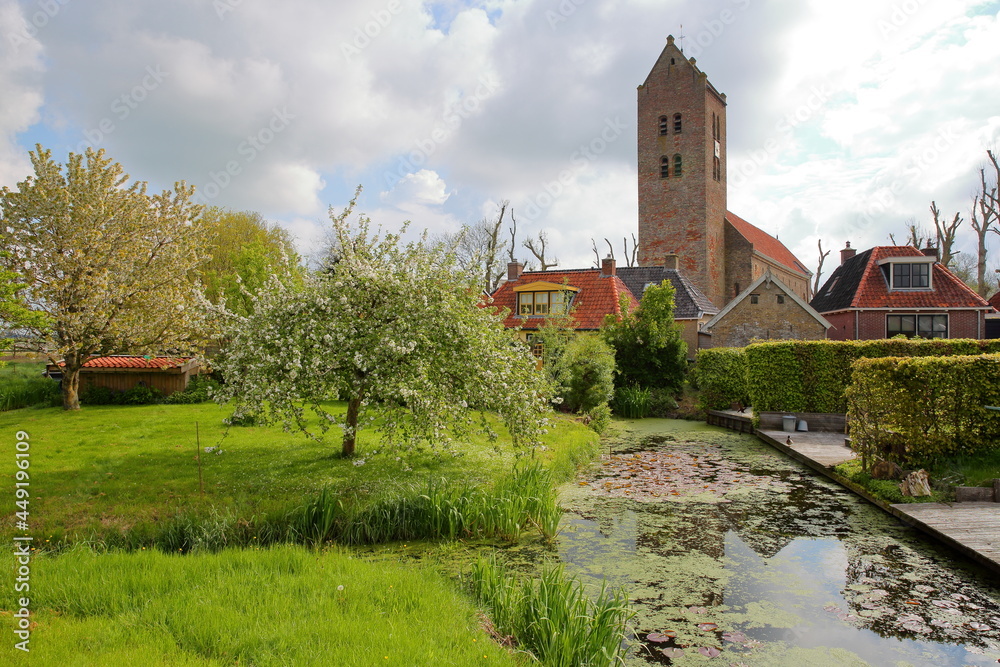 The Roman church and traditional houses in Bozum, Friesland, Netherlands, a small village located 20km South from Leeuwarden