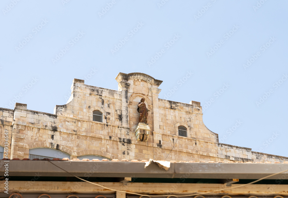 The statue of the prophet on the roof of the Saint saviour monastry in the old city of Jerusalem, Israel