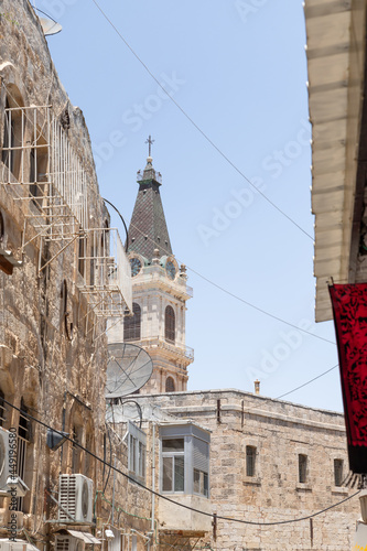 View from street Les Freres to the bell tower of the Saint saviour monastry in the old city of Jerusalem, Israel photo