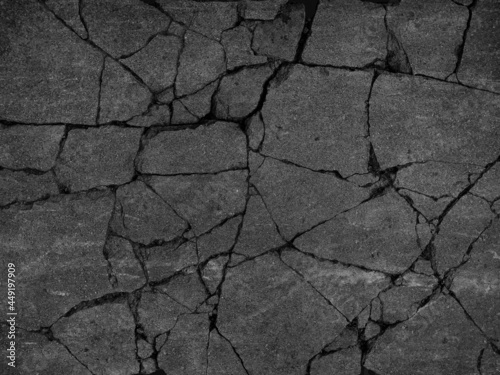 Old dark gray dirty rough uneven grimy paved way. Grunge broken chipped lump boulder city asphalt. Damaged worn lane avenue pitted break. Shabby rustic big granular pieces material of 3d travel design