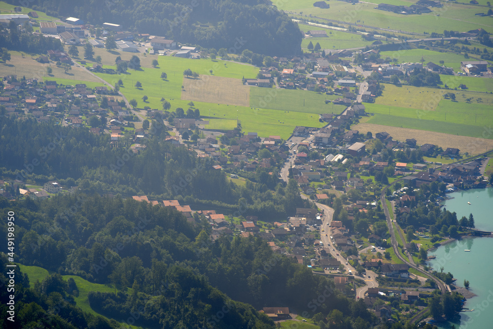 Aerial view of village Brienz with lake in the background at Bernese Highland on a sunny summer day. Photo taken July 21st, 2021, Brienz, Switzerland.