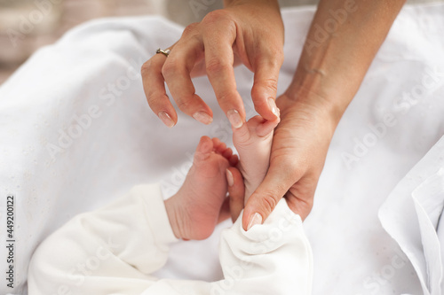 Small baby feet in mother hands