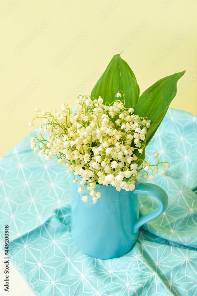 Vase with beautiful lily-of-the-valley flowers on table, closeup