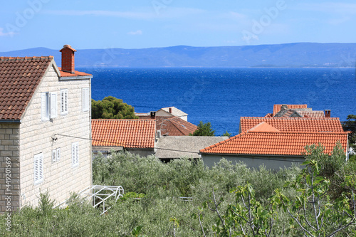 The houses in the beautiful Croatian village with the sea view and the land on the horizon, Brac island, Croatia