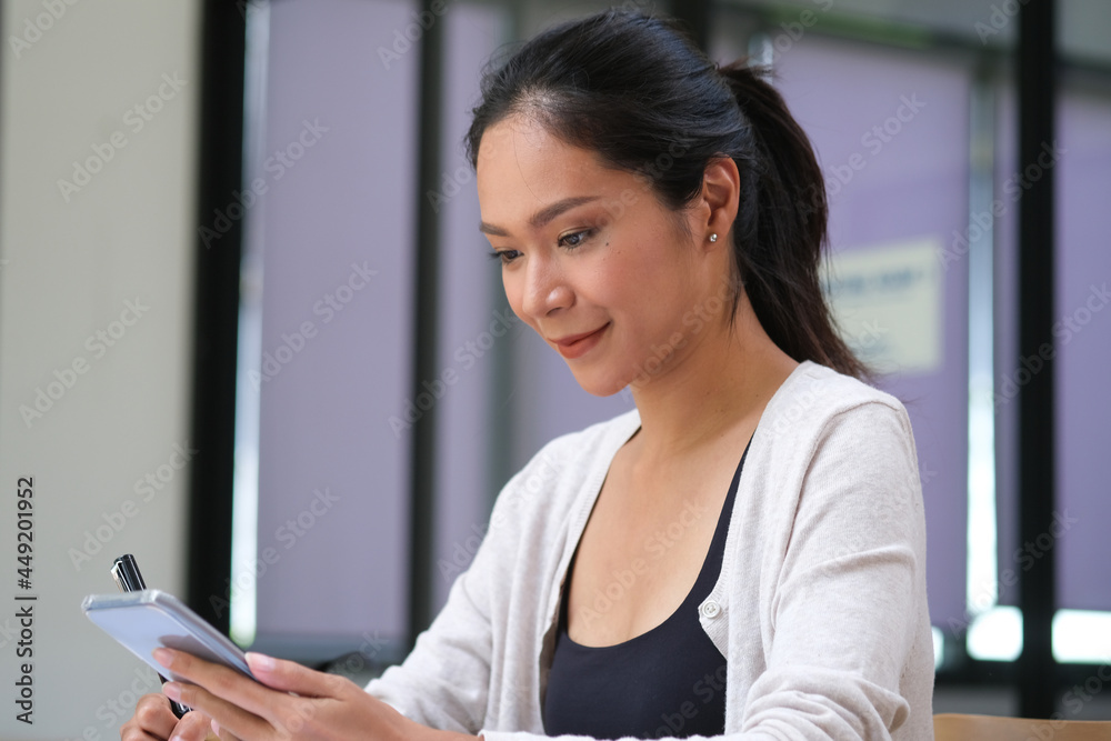 Portrait with Asian woman use cellphone in the office. Portrait with Asian woman use cellphone in the office.