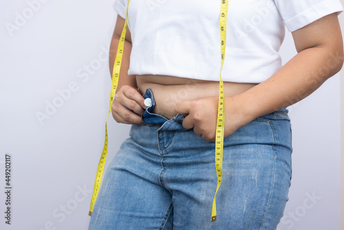 beautiful fat woman standing on white background she wants to lose weight The concept of underarm liposuction surgery lose belly fat and break down thigh fat.