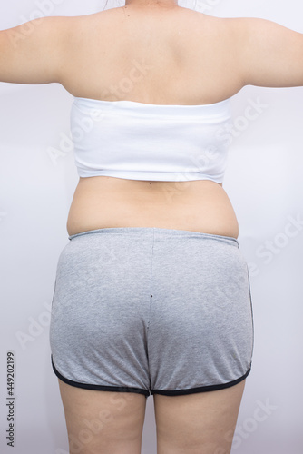 beautiful fat woman with tape measure on white background she wants to lose weight The concept of underarm liposuction surgery lose belly fat and break down thigh fat.