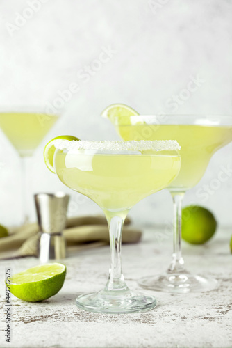 Glasses with tasty daiquiri cocktail on light background