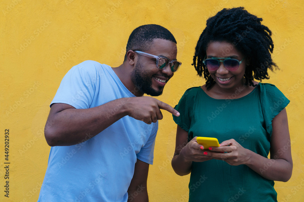 Black couple using a mobile phone Black couple using a mobile phone