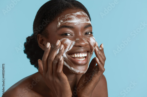 Canvas Print Close up portrait of beautiful black girl wash her face with cleansing face foam