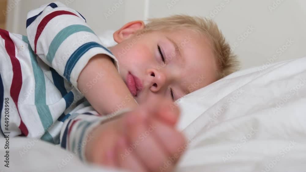 Sleeping Child in Bed. Cute Little Kid Sleeps Sweetly on Cozy White Blanket on its Side. 2 Years Old Child Sleeping in Crib. Face Close-up. Young Boy Lying in Bed on Pillow during the Day Sleep, 4K Sleeping Child in Bed. Cute Little Kid Sleeps Sweetly on Cozy White Blanket on its Side. 2 Years Old Child Sleeping in Crib. Face Close-up. Young Boy Lying in Bed on Pillow during the Day Sleep, 4K