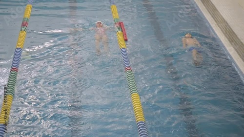 Five young latin kids practicing backstroke