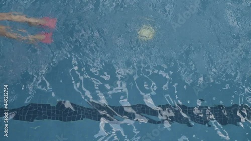 Two young latin girls swimming backstroke style