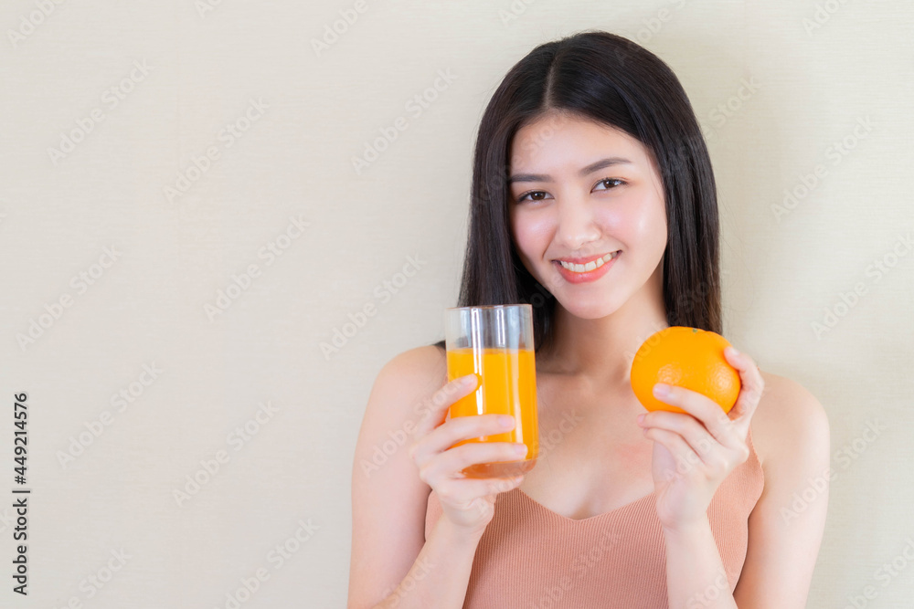 Beautiful beauty woman Asian cute girl feel happy drinking orange juice for good health in the morning , enjoying time in her home white bedroom background - lifestyle beauty woman concept Beautiful beauty woman Asian cute girl feel happy drinking orange juice for good health in the morning , enjoying time in her home white bedroom background - lifestyle beauty woman concept