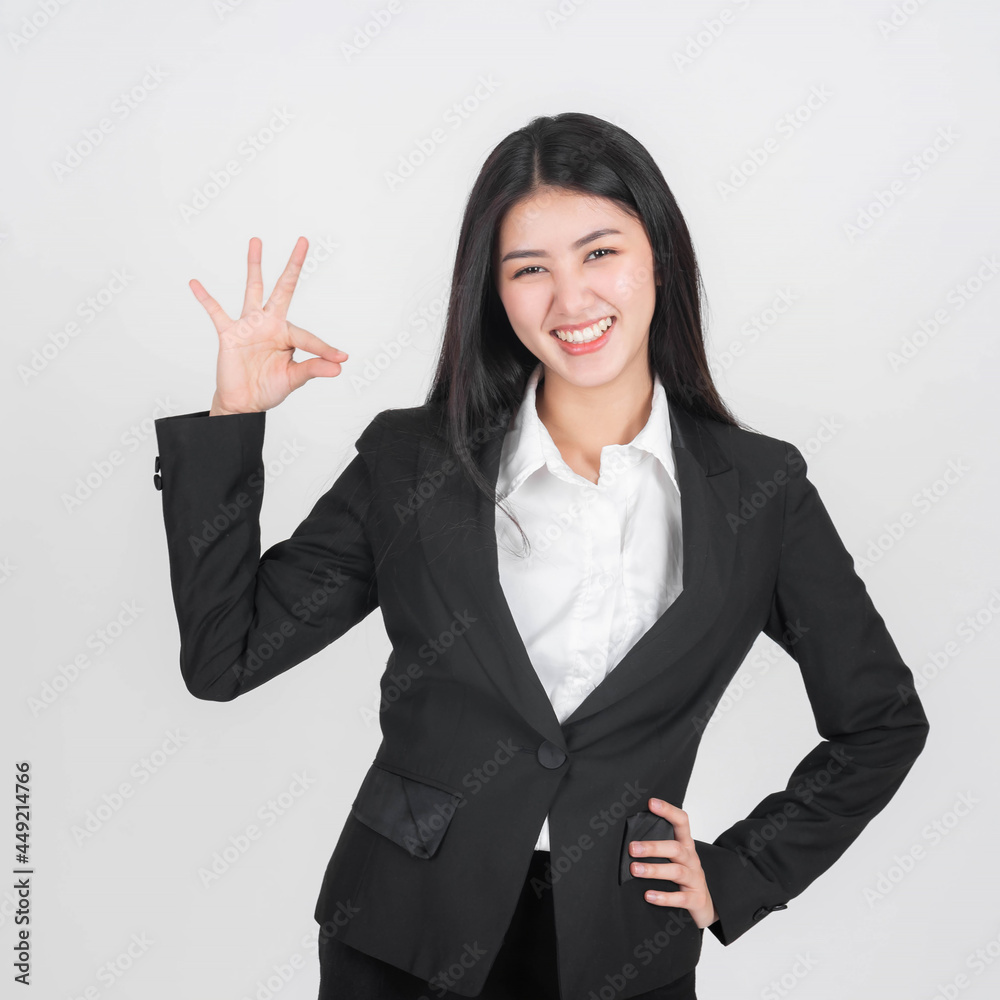 Portrait beautiful working Asian woman with happiness showing ok hand sign for perfection business on white background Portrait beautiful working Asian woman with happiness showing ok hand sign for perfection business on white background