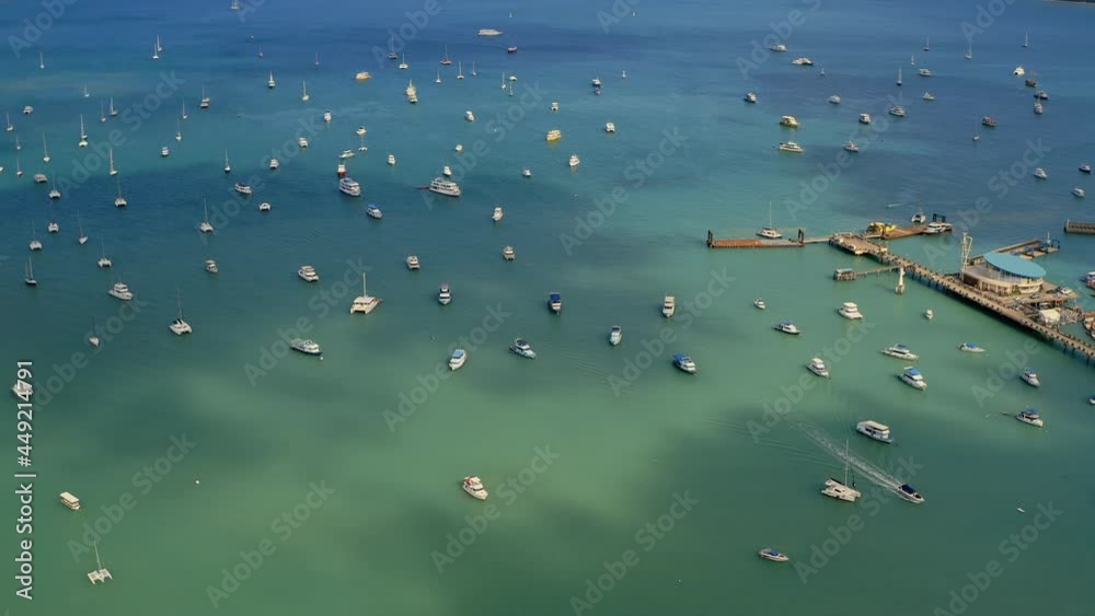Aerial view of the marina lot. Docked sailboats and catamarans in yacht club. Lack of tourists due to lockdown of tropical countries. The consequences of coronavirus for the tourism business. Aerial view of the marina lot. Docked sailboats and catamarans in yacht club. Lack of tourists due to lockdown of tropical countries. The consequences of coronavirus for the tourism business.