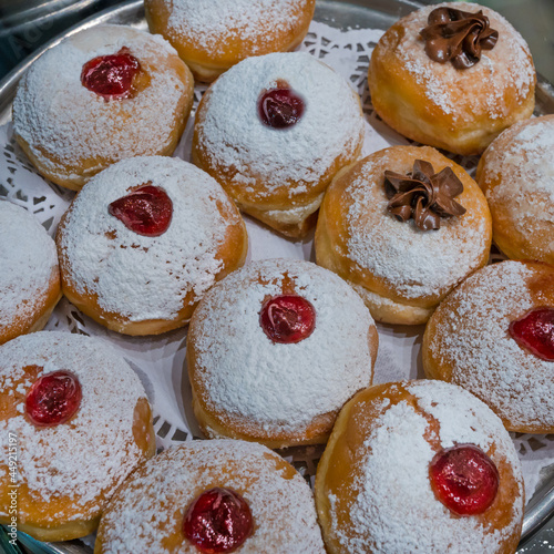 Fresh donuts at the bakery display for Hanukkah celebration. Selective focus. photo