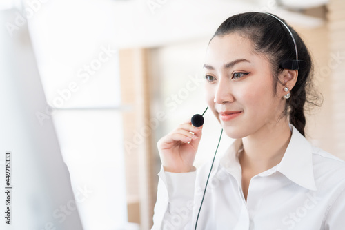 Asian call center woman worker at work. Female customer support operator with headset working in the office. Contact center and customer service by headphone concept