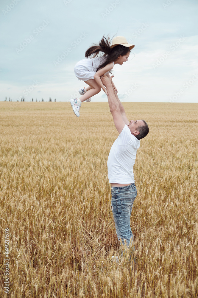 Father and daughter have fun in the field . Happy family concept. Father and daughter have fun in the field . Happy family concept.