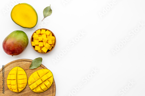 Tropical mango slices and cubes in wooden bowl