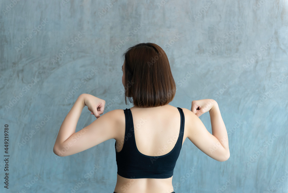 Close up asian beautiful sport girl on wall of gym,Thailand love health,Slim woman workout concept Close up asian beautiful sport girl on wall of gym,Thailand love health,Slim woman workout concept