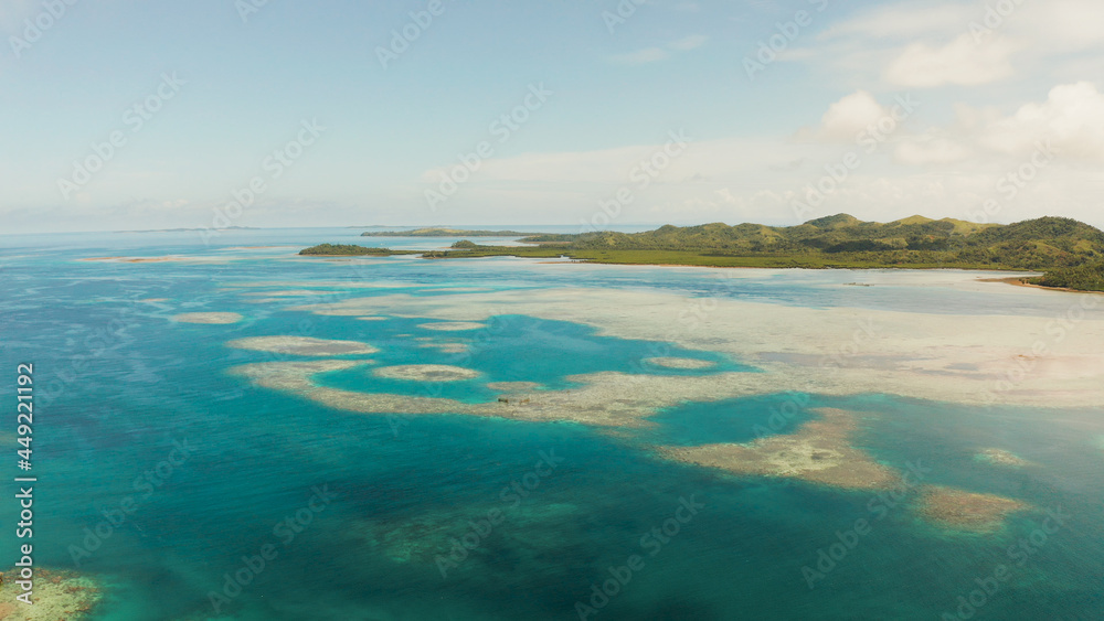 Tropical islands in turquoise lagoon and coral reef water, aerial view. Bucas grande, Philippines. Summer and travel vacation concept.
