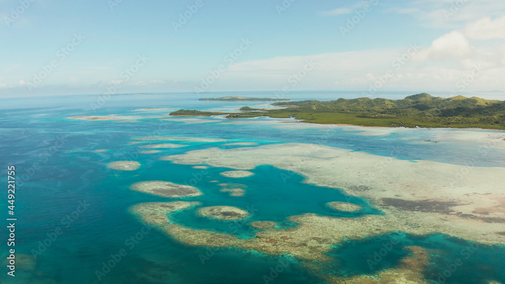 Islands are surrounded by an atoll and a coral reef with blue water top view. Bucas grande, Philippines. Summer and travel vacation concept.