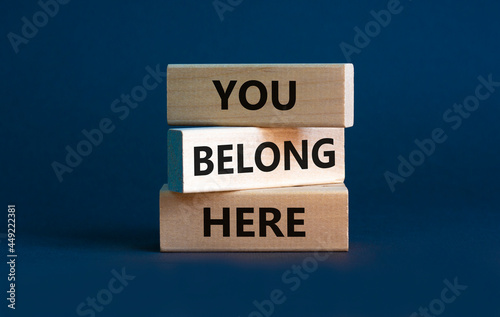 You belong here symbol. Wooden blocks with words 'You belong here' on beautiful grey background. Diversity, business, inclusion and belonging concept. © Dzmitry