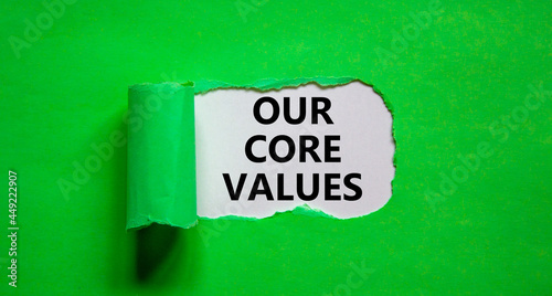 Our core values symbol. Words 'Our core values' appearing behind torn green paper. Beautiful green background. Business, our core values concept, copy space.