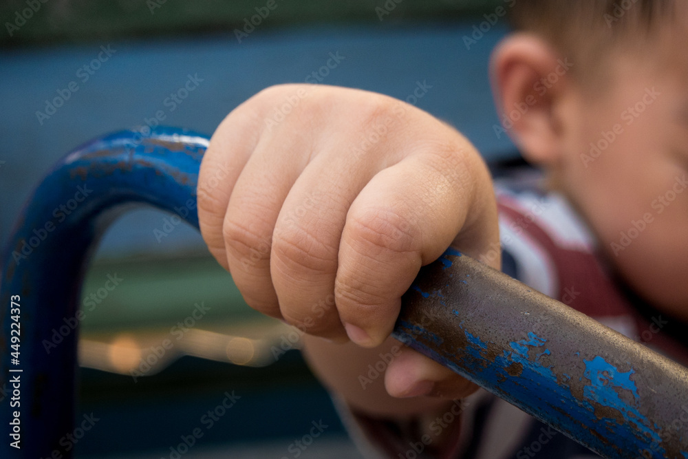 Child hand holding handlebar steel