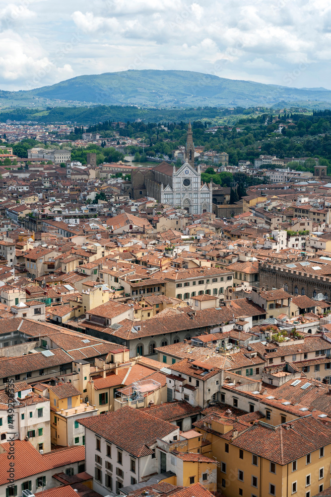 Red rooftops of Florence with the Santa Croce Basilica in the background.