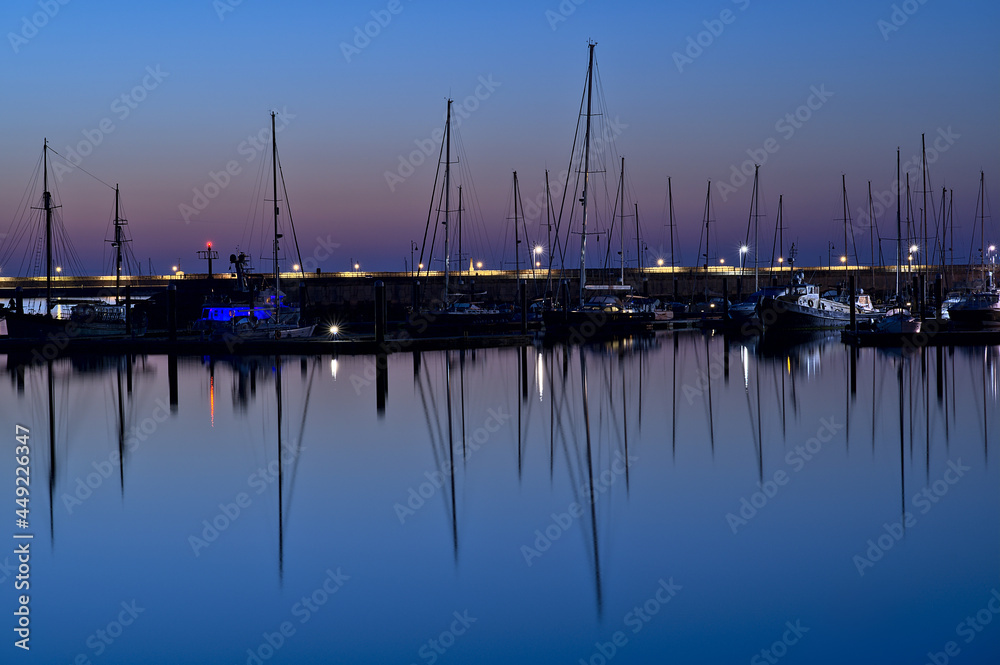 Beautiful early morning view of boats and yachts in West Pier of famous Dun Laoghaire harbor during the blue hour before sunrise, Dublin, Ireland. Marine themed Beautiful early morning view of boats and yachts in West Pier of famous Dun Laoghaire harbor during the blue hour before sunrise, Dublin, Ireland. Marine themed