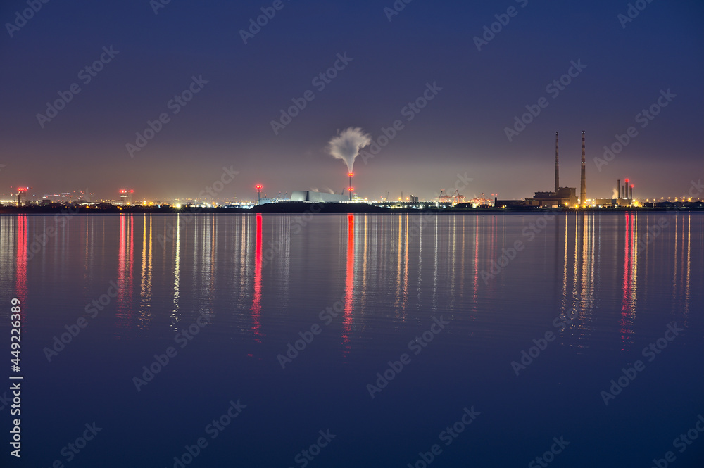 Spectacular early morning view of Dublin Waste to Energy (Covanta Plant), Poolbeg CCGT and Pigeon House Power Station view from Dun Laoghaire Harbor with light reflection in water, Dublin, Ireland