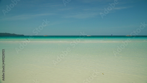 Seascape: blue sea and tropical beach on a background of blue sky. Summer and travel vacation concept. Boracay, Philippines © Alex Traveler
