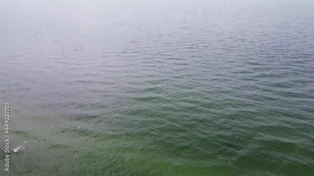 Aerial top view of ocean waves breaking on a beach. Drone view of the sea and coast line at summer day. Blue sky over rippled water surface. Serene landscape of the shore. Spending vacations on nature Aerial top view of ocean waves breaking on a beach. Drone view of the sea and coast line at summer day. Blue sky over rippled water surface. Serene landscape of the shore. Spending vacations on nature