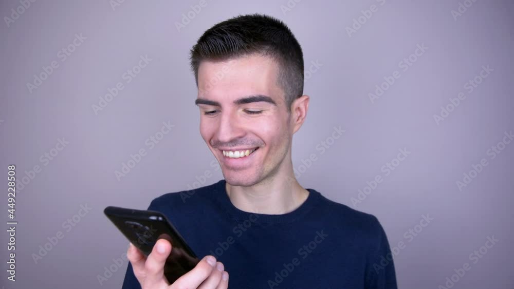 Strongly laughing man looking at the smartphone Strongly laughing man looking at the smartphone