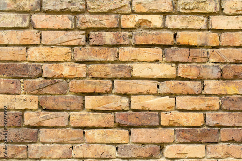 brick wall with different yellow tones 