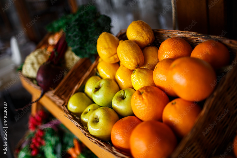 basket with lemons, oranges and apples on the counter in a supermarket close-up basket with lemons, oranges and apples on the counter in a supermarket close-up