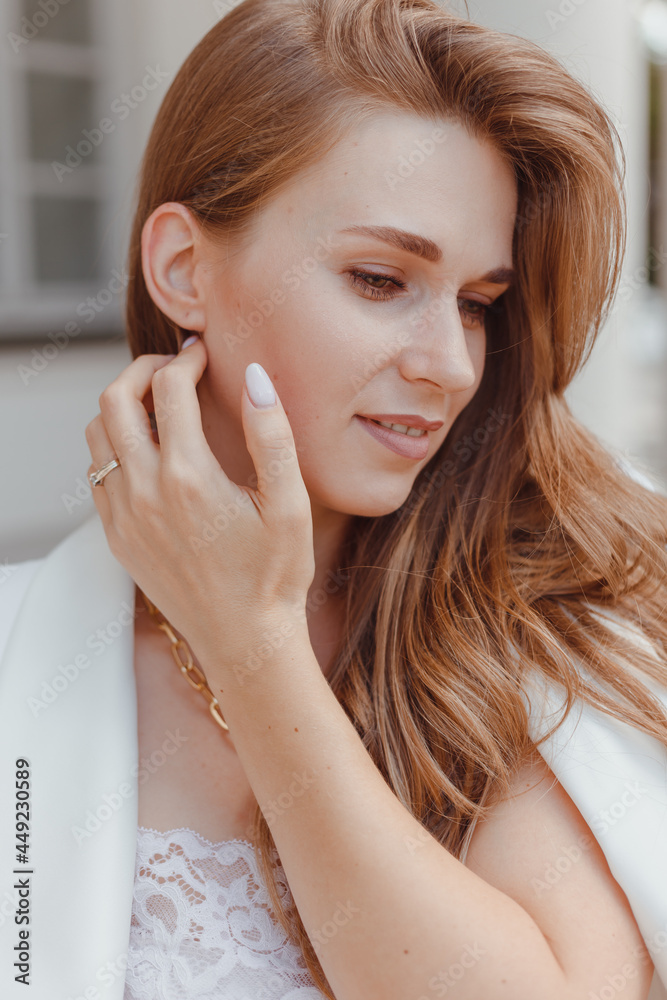 Elegant young woman portrait in while fashion look outdoors Elegant young woman portrait in while fashion look outdoors