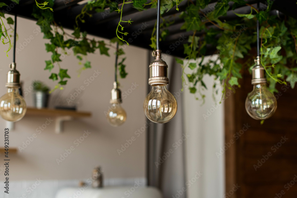 Wooden kitchen room with dining table and bar chairs, parquet floor. Kitchen open space room with bookshelf, wooden light furniture. Bulb light. Wooden kitchen room with dining table and bar chairs, parquet floor. Kitchen open space room with bookshelf, wooden light furniture. Bulb light.