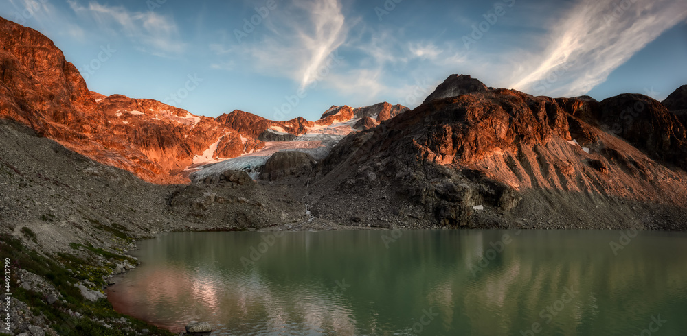 Panoramic View of Vibrant Glacier Lake up in Rocky Mountains in Canadian Nature Landscape. Sunny Summer Sunset. Wedgemount Lake Hike in Whistler, British Columbia, Canada. Colorful Background Panorama