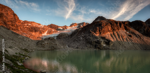 Fototapeta Naklejka Na Ścianę i Meble -  Panoramic View of Vibrant Glacier Lake up in Rocky Mountains in Canadian Nature Landscape. Sunny Summer Sunset. Wedgemount Lake Hike in Whistler, British Columbia, Canada. Colorful Background Panorama