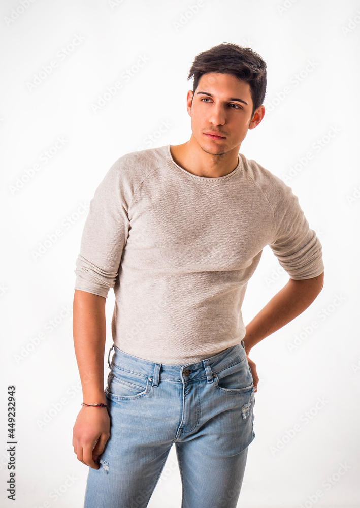 Fit handsome young man standing confident in casual clothes isolated on white Fit handsome young man standing confident in casual clothes isolated on white