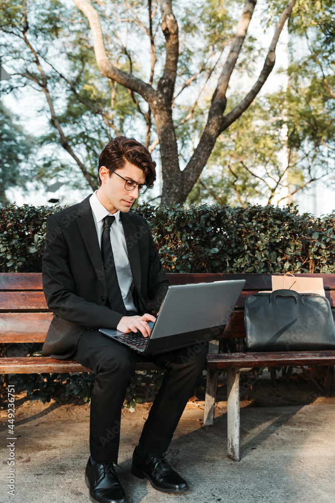 young man in casual suit working out in a park outdoors