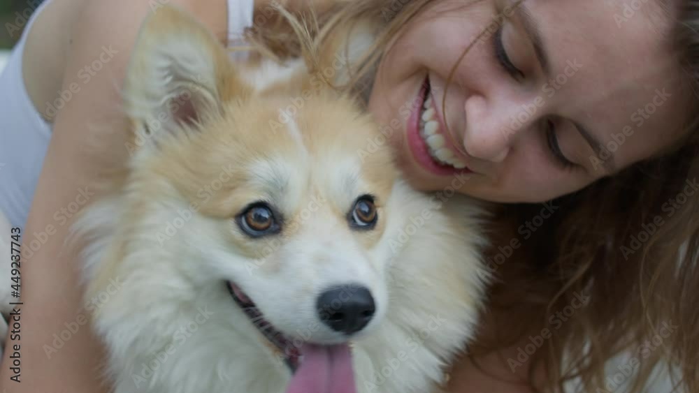 Happy mature female pet owner relaxing and embracing. Young woman hugging dog in the city in summer Happy mature female pet owner relaxing and embracing. Young woman hugging dog in the city in summer