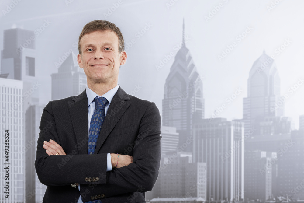 Adult businessman standing with skyline on background Adult businessman standing with skyline on background