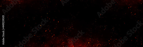 Fire embers particles over black background. Fire sparks background. Abstract dark glitter fire particles lights. 