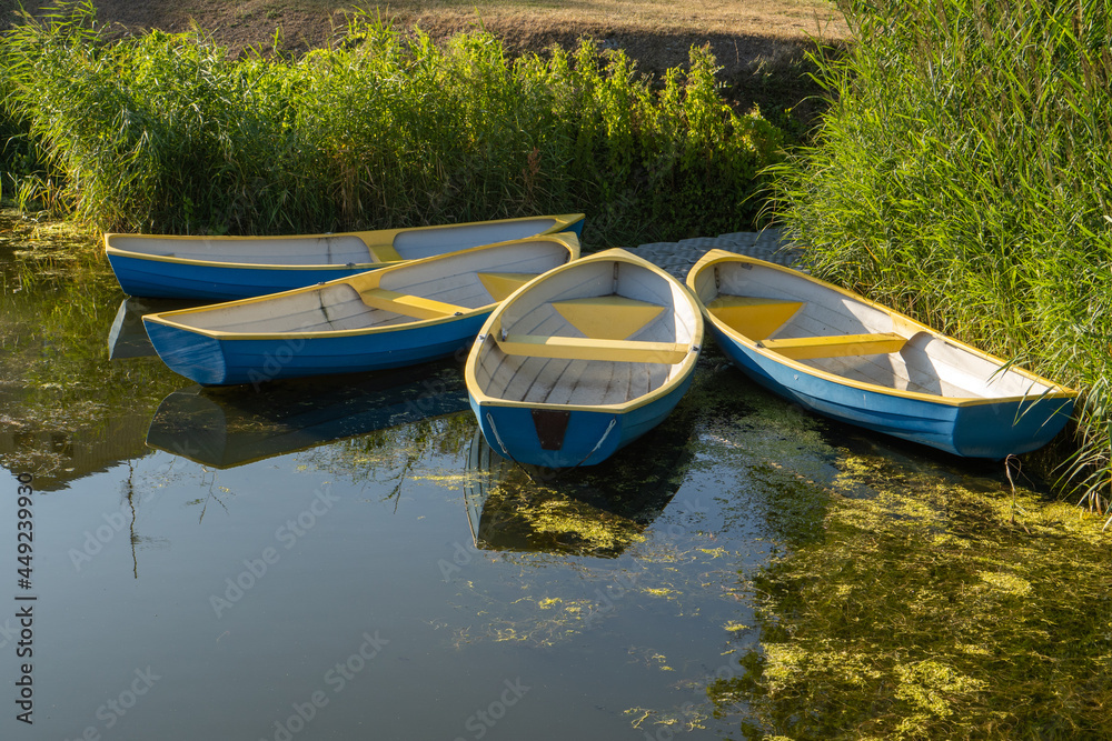 four boats moored on shore